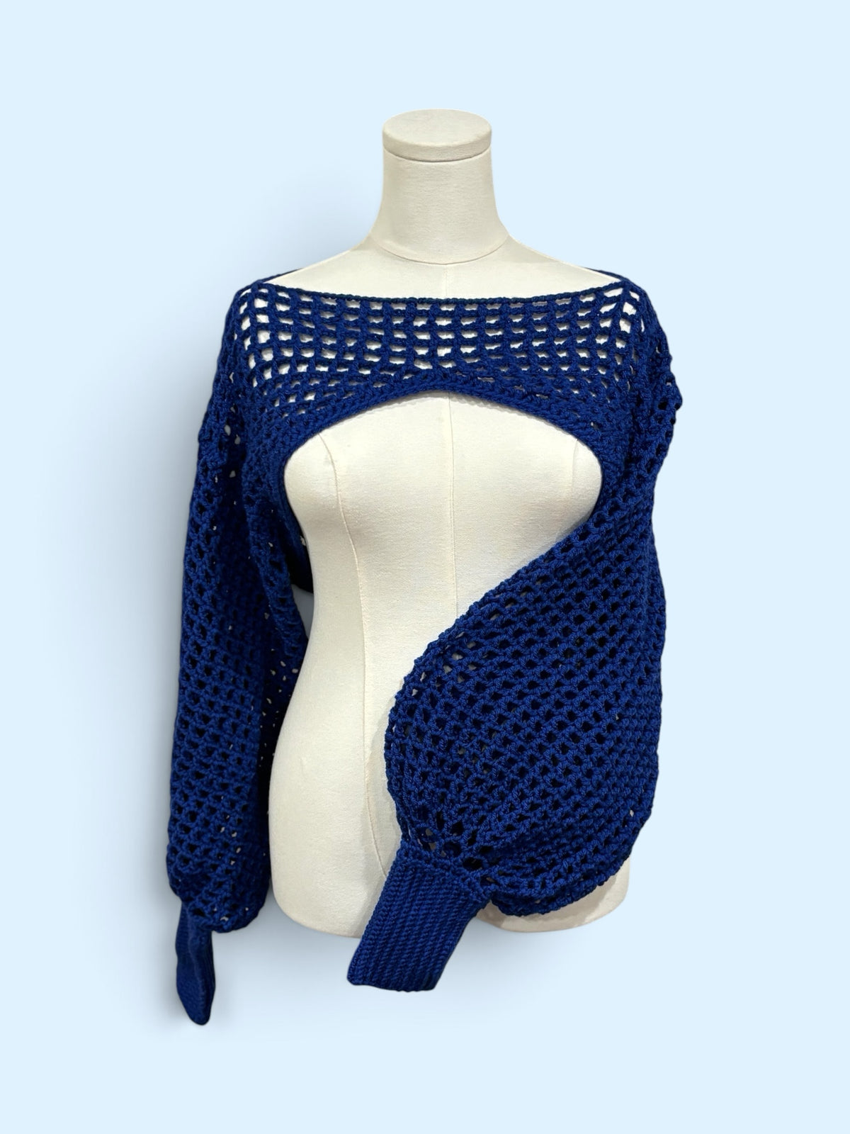 Nana's Cottage navy blue handmade crochet bolero shrug with open-knit mesh pattern and voluminous balloon sleeves.